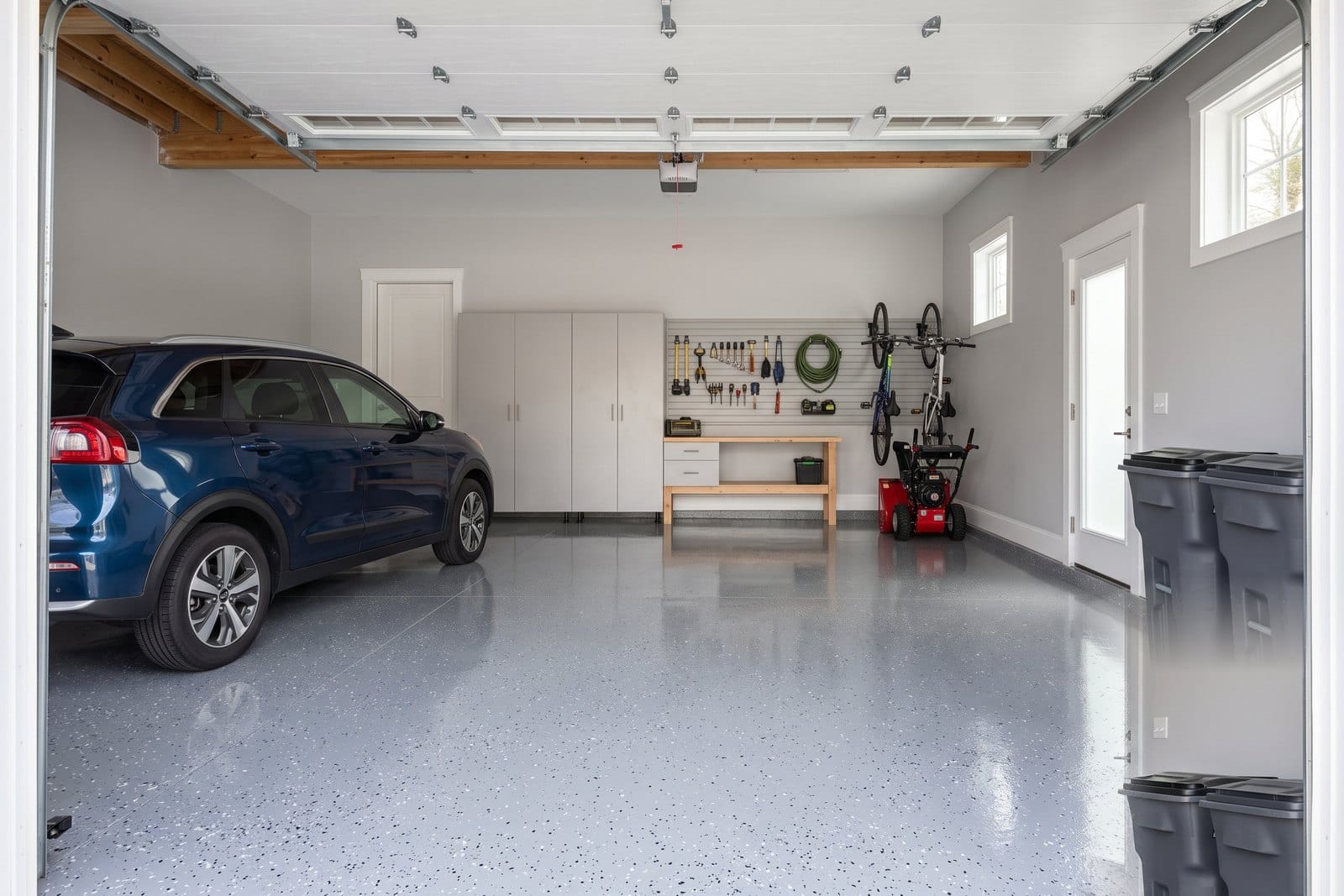 Glossy flake-finished epoxy garage floor in a clean MetroWest Boston garage, durable coating over prepared concrete