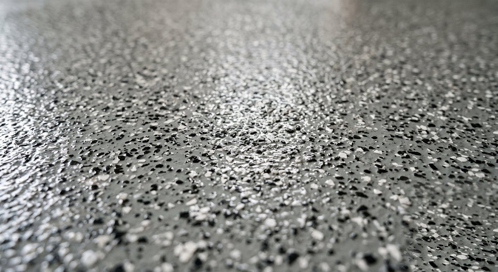 Finished decorative flake epoxy garage floor with a glossy, durable coating in a MetroWest Boston garage