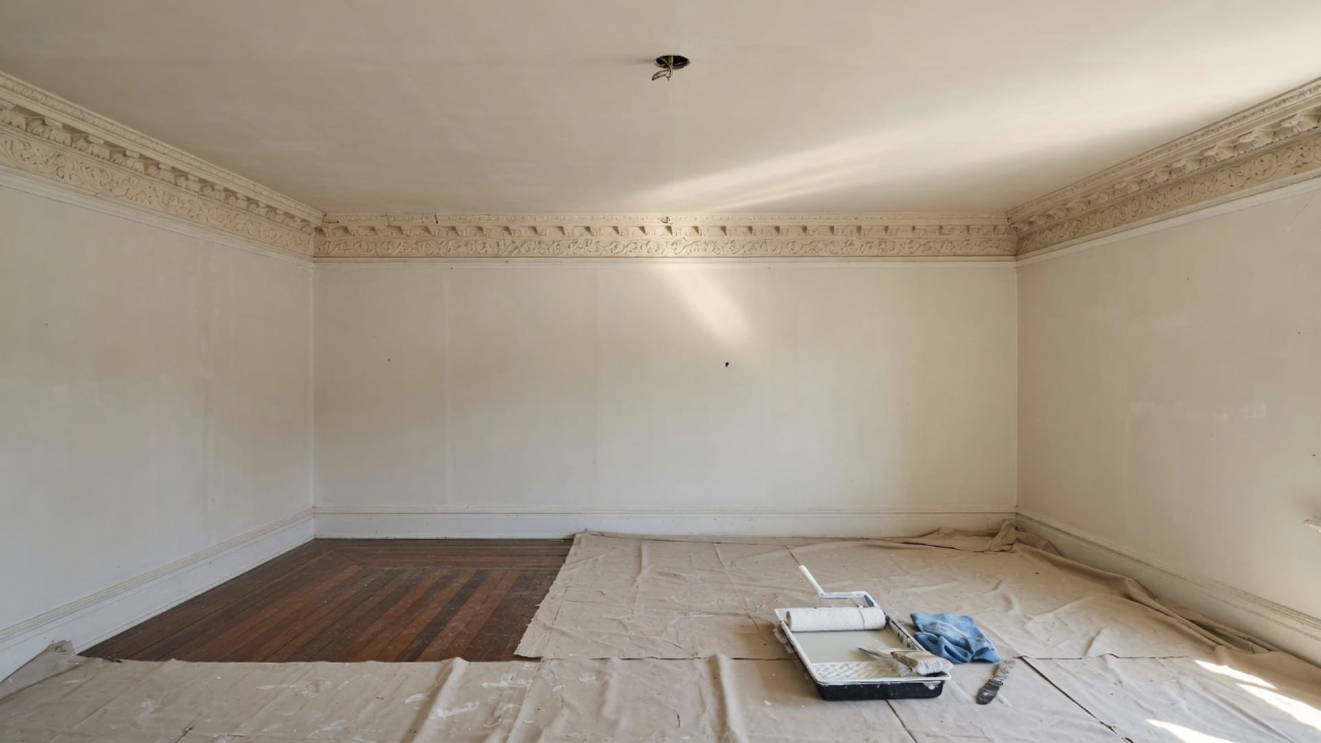 Fresh skim-coated ceiling meeting original crown in a Wellesley MA dining room, soft daylight