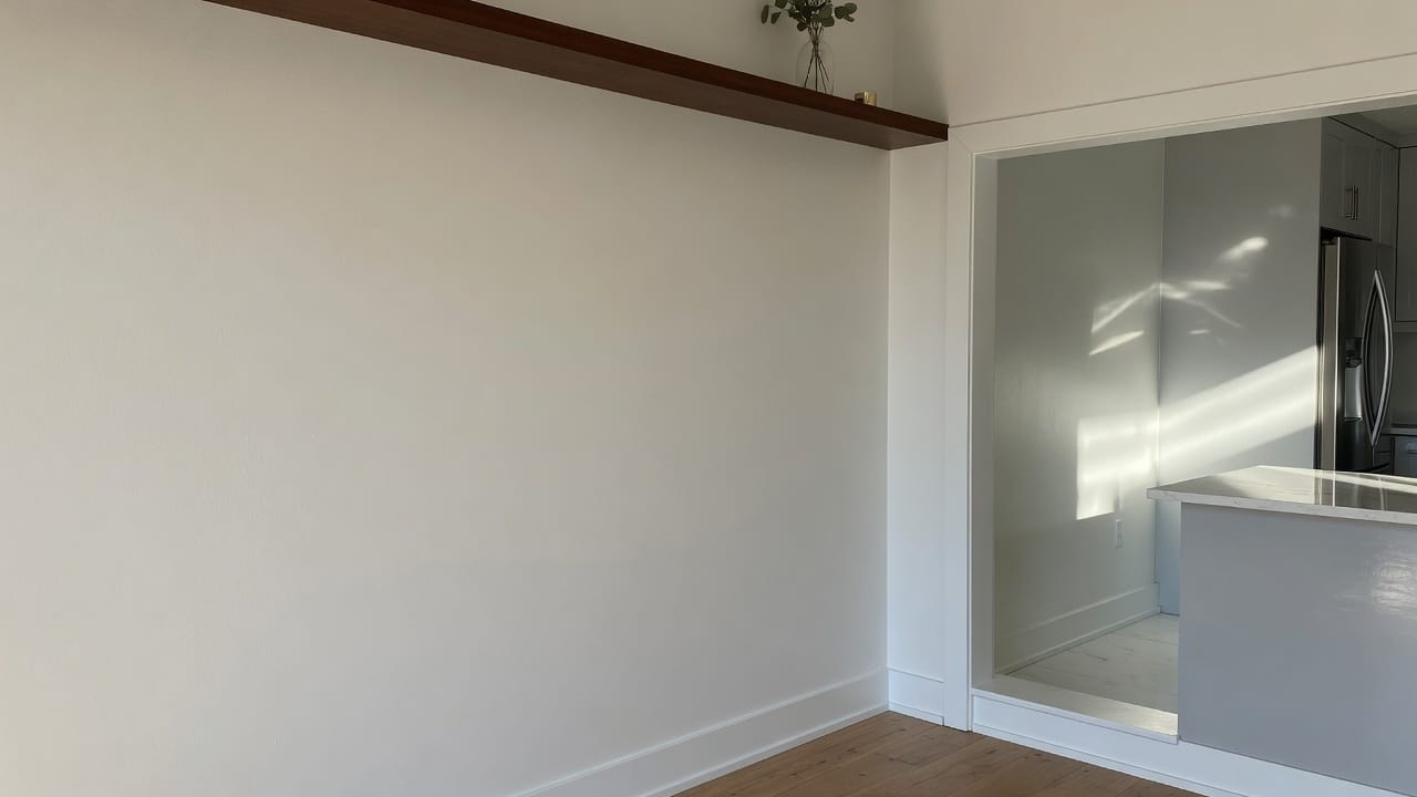 Eggshell and satin interior walls meeting in a MetroWest MA home, morning light, no people